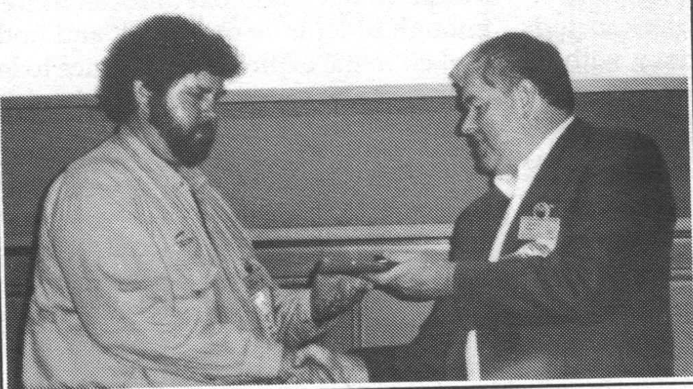 Schulman accepts hof award for Red Planet from Hogan.